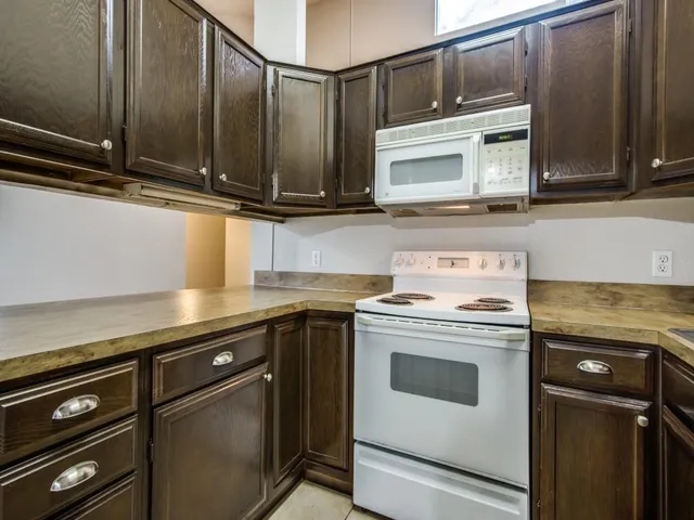 a kitchen with stainless steel appliances granite countertop a stove and a microwave