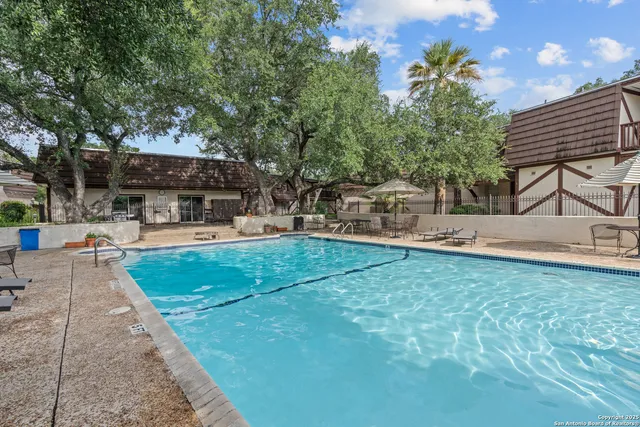 a view of a backyard with sitting area