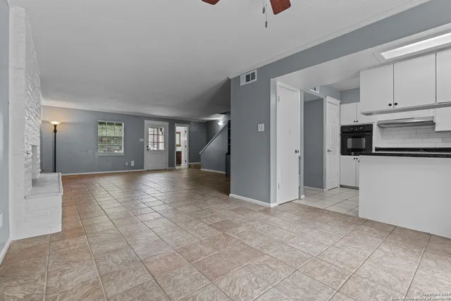 a view of a kitchen with a sink and a refrigerator
