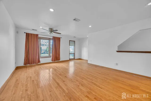 a view of a livingroom with a ceiling fan and window