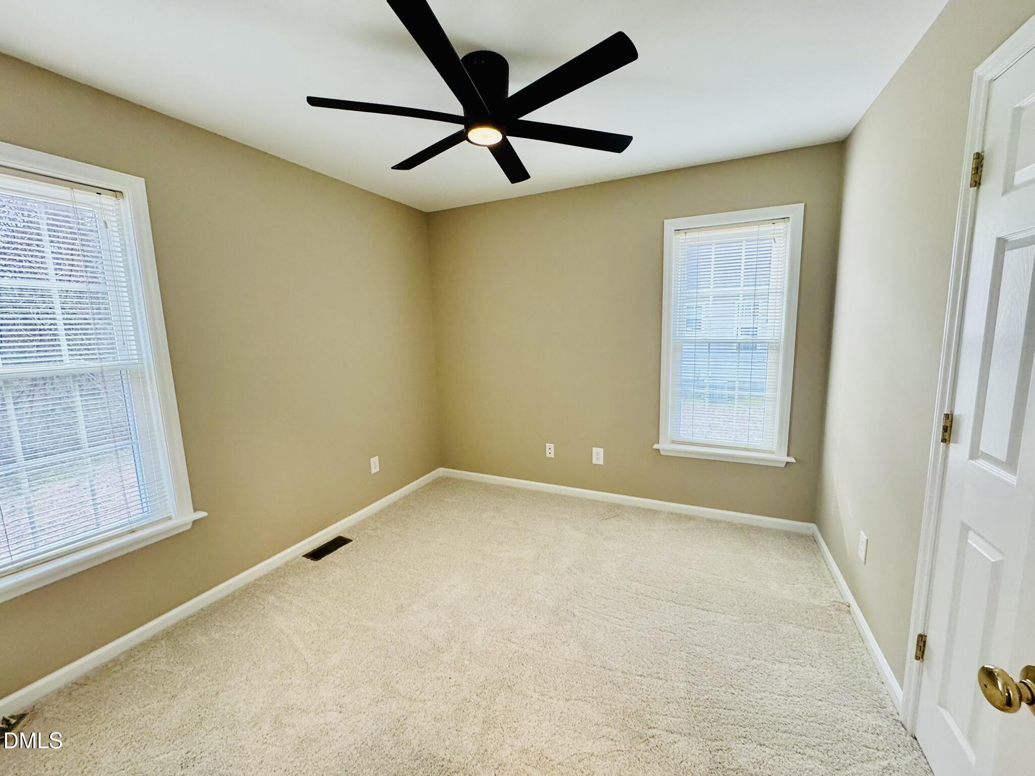 6904 Fox Haven Place Raleigh, NC 27616 - Photo 15 of 17 an empty room with windows and fan