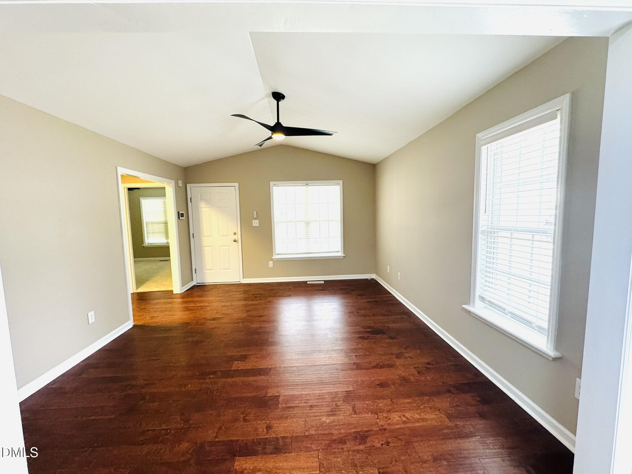 6904 Fox Haven Place Raleigh, NC 27616 - Photo 4 of 17 a view of an empty room with wooden floor and a window
