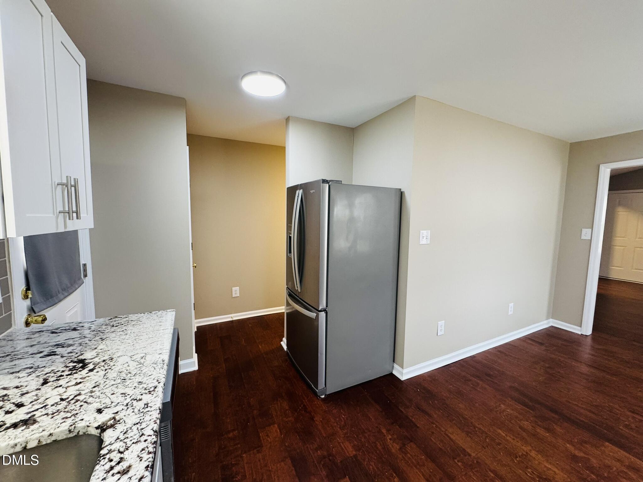6904 Fox Haven Place Raleigh, NC 27616 - Photo 7 of 17 a view of a kitchen with wooden floor and refrigerator