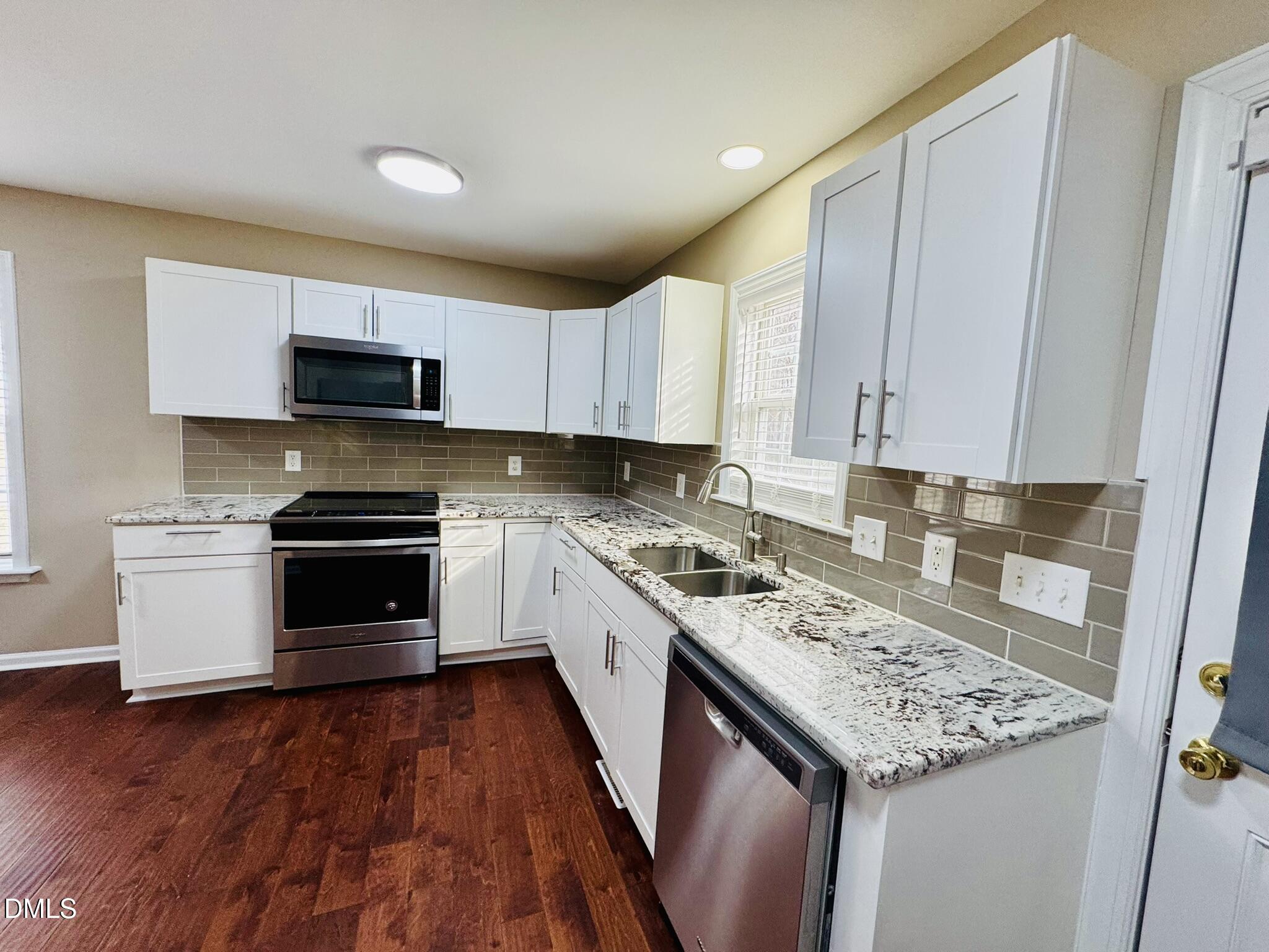 6904 Fox Haven Place Raleigh, NC 27616 - Photo 8 of 17 a kitchen with a stove sink and a microwave