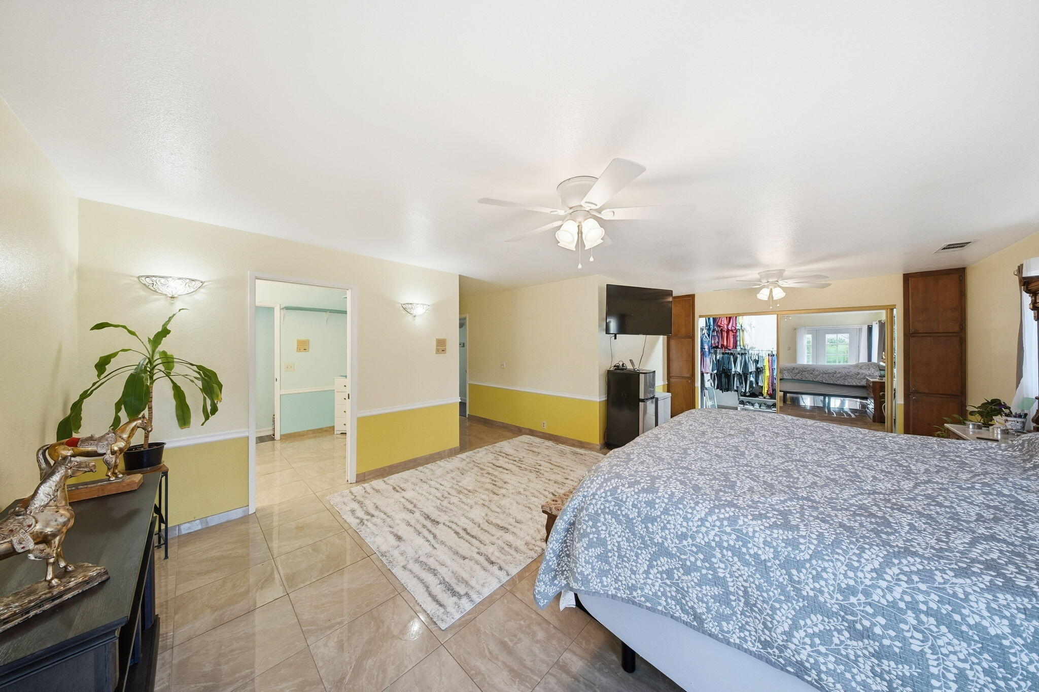 13520 Crystal Street Red Bluff, CA 96080 - Photo 13 of 24 a spacious bedroom with a bed and a walk in closet with wooden floor