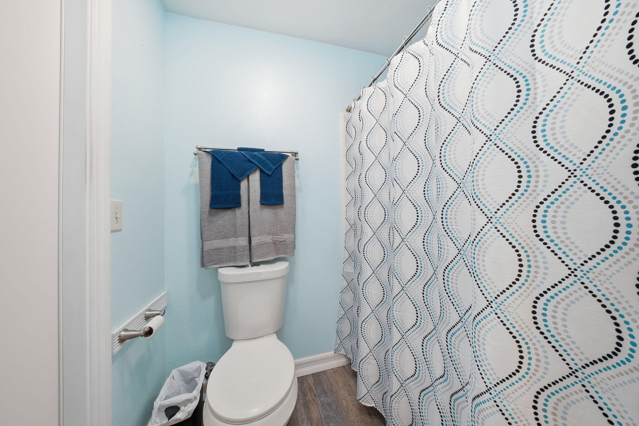 13520 Crystal Street Red Bluff, CA 96080 - Photo 15 of 24 a white toilet sitting next to a shower curtain