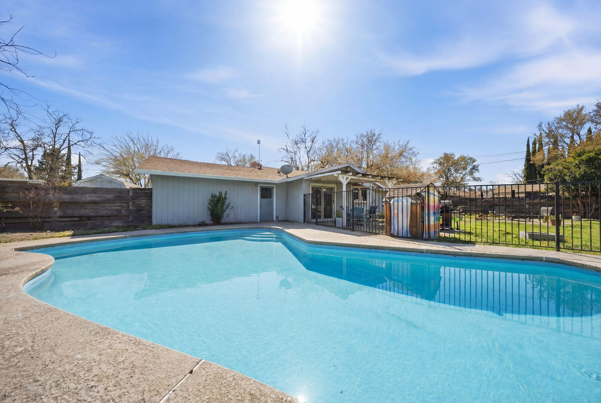 13520 Crystal Street Red Bluff, CA 96080 - Photo 19 of 24 a view of a house with swimming pool and a yard
