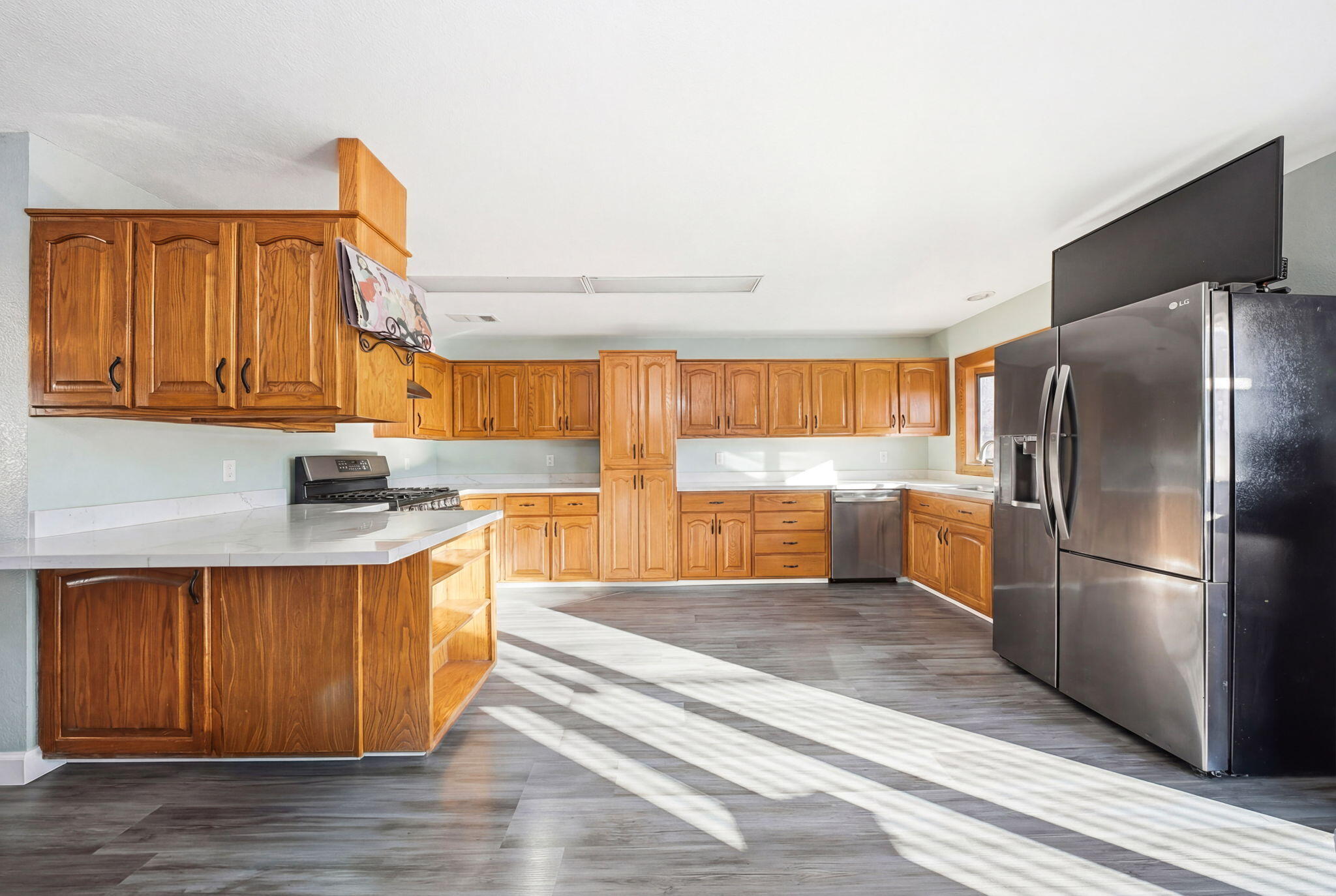 13520 Crystal Street Red Bluff, CA 96080 - Photo 6 of 24 a kitchen with stainless steel appliances granite countertop a refrigerator a sink and a stove