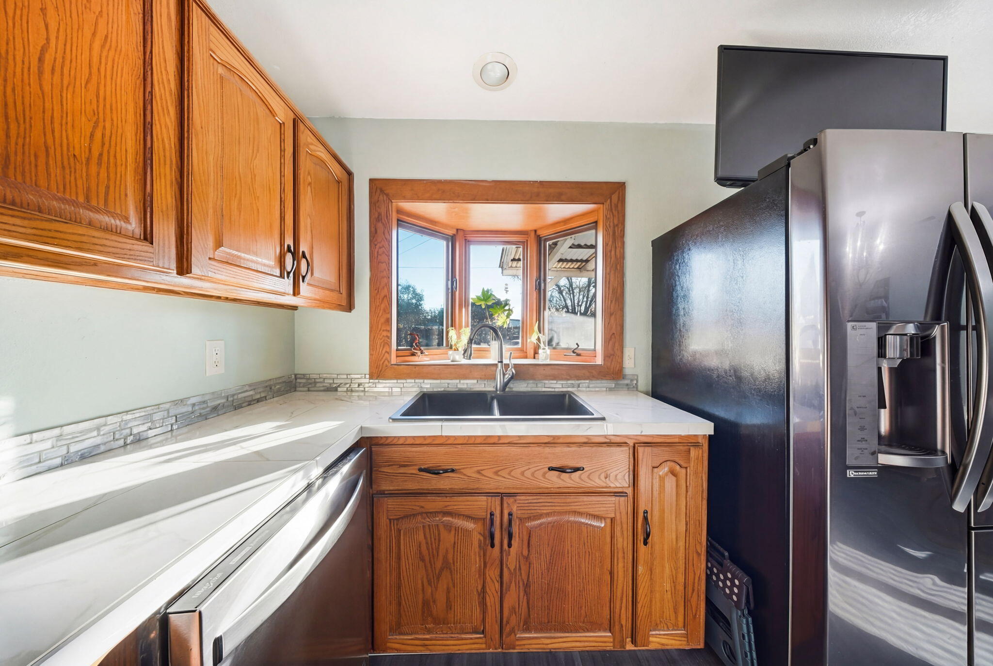 13520 Crystal Street Red Bluff, CA 96080 - Photo 7 of 24 a kitchen with stainless steel appliances granite countertop a sink a refrigerator and a granite counter tops