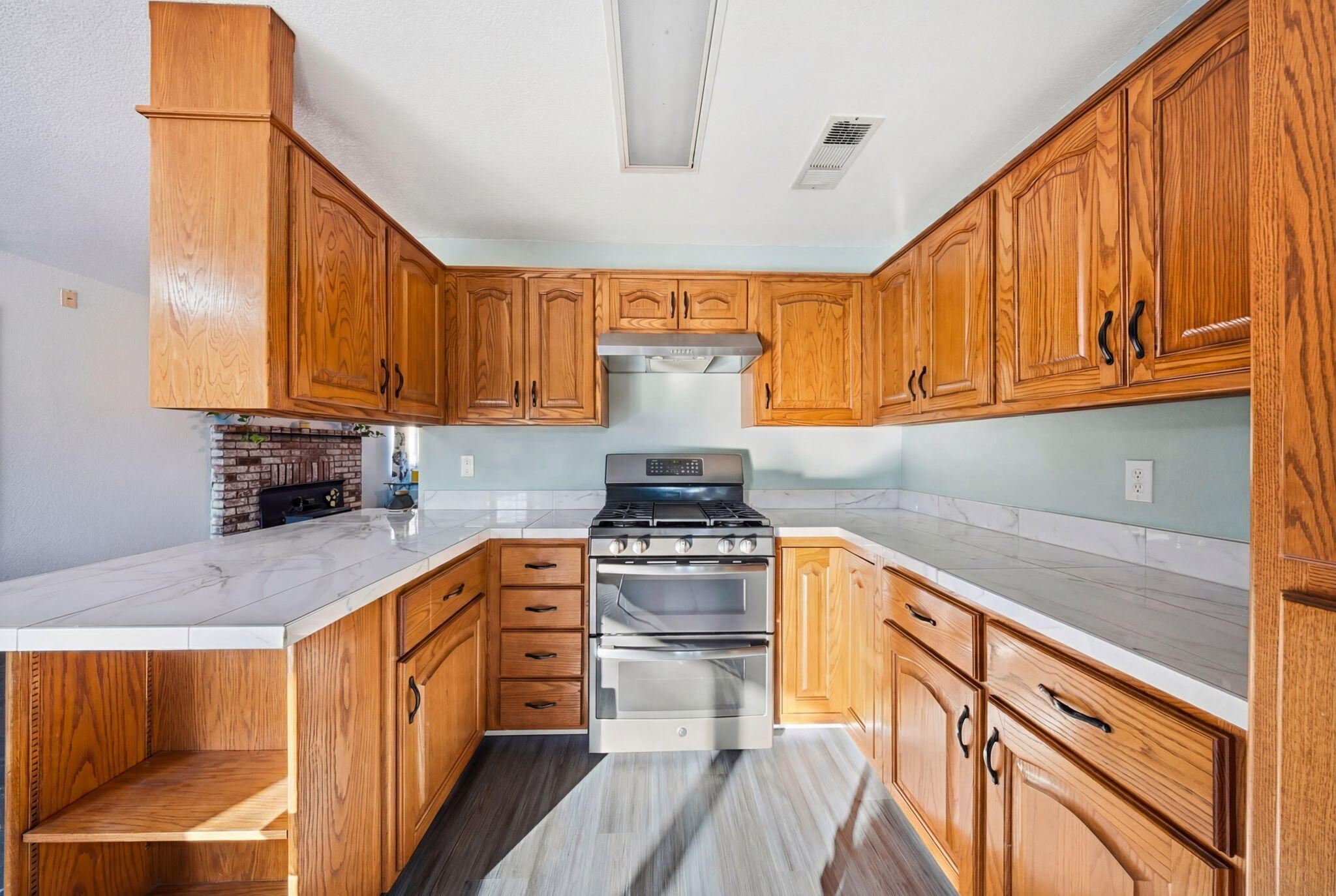 13520 Crystal Street Red Bluff, CA 96080 - Photo 8 of 24 a kitchen with granite countertop wooden cabinets stainless steel appliances and a counter space