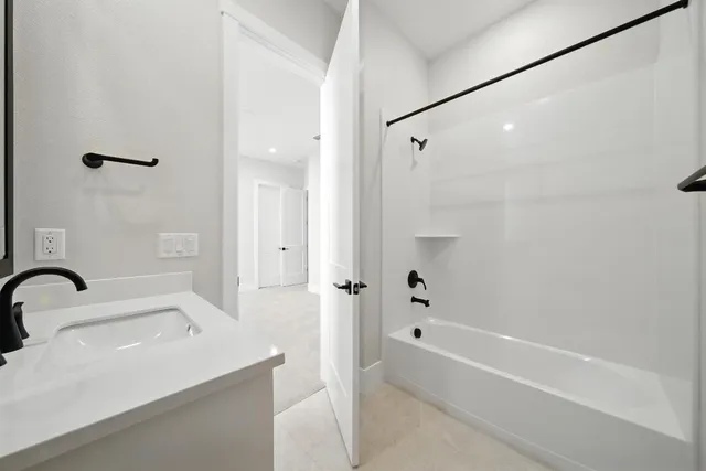 a bathroom with a sink a mirror and a bathtub