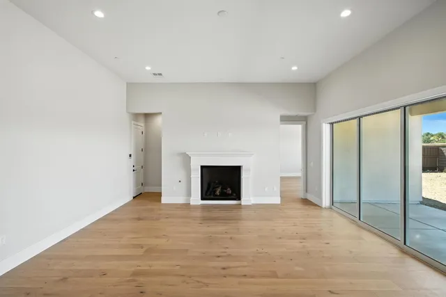 a view of a livingroom with a fireplace and window