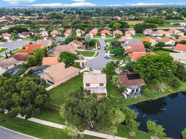 an aerial view of a houses with a lake