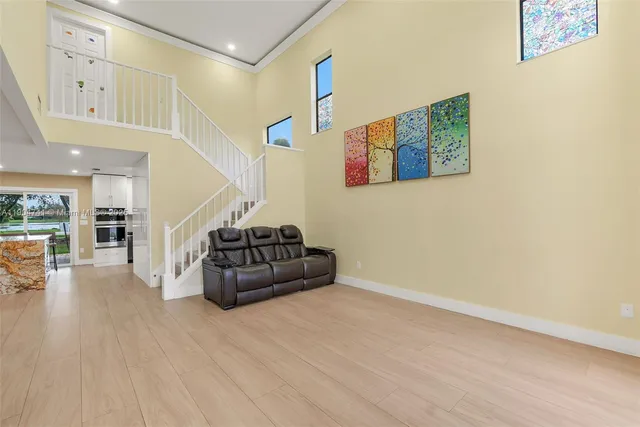a living room with furniture and kitchen view