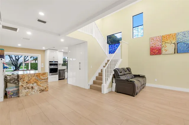 a living room with furniture gym equipment and a flat screen tv