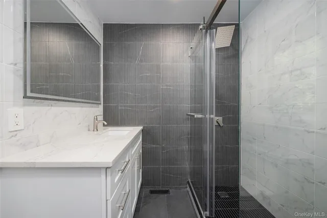 a bathroom with a sink a mirror and shower