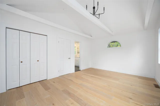 a bathroom with a double vanity sink a toilet a mirror and shower
