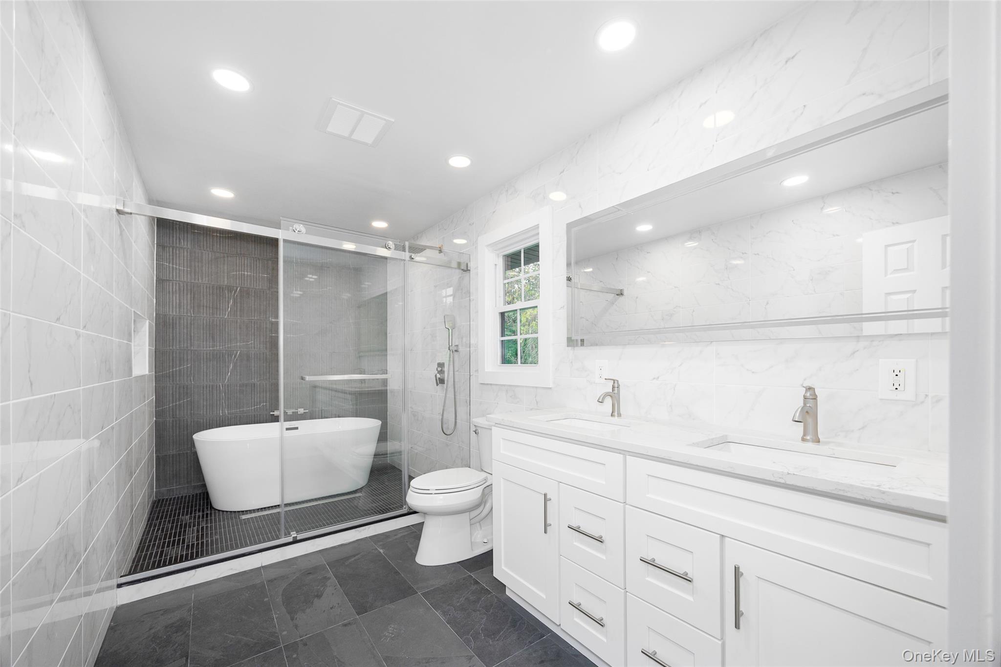 382 Slate Quarry Road Rhinebeck, NY 12572 - Photo 17 of 31 a bathroom with a double vanity sink a toilet a mirror and shower