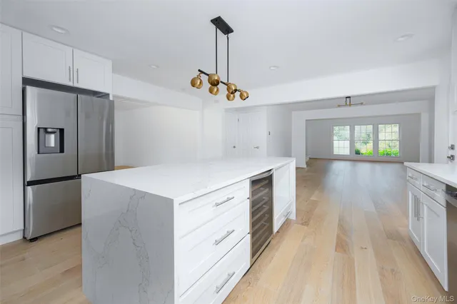 a kitchen that has a lot of cabinets and wooden floor