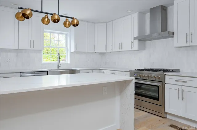 a kitchen with granite countertop a stove a sink and a window