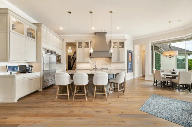 a large kitchen with a table and chairs