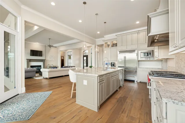 a kitchen with stainless steel appliances granite countertop a stove top oven and cabinets