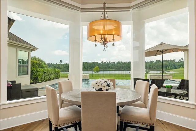 a view of a dining room with furniture wooden floor and a floor to ceiling window