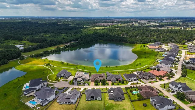 an aerial view of a house with a garden and lake view