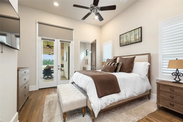 a bedroom with a bed and glass walk in closet