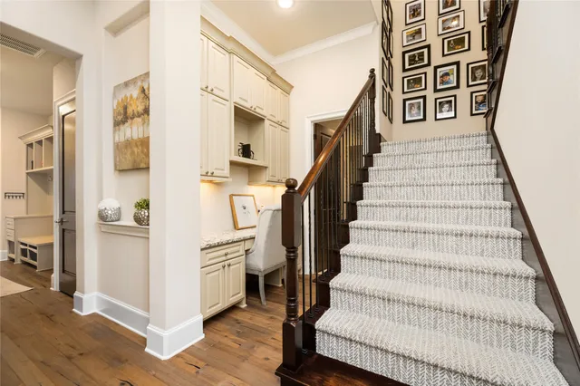 a view of entryway and hall with wooden floor