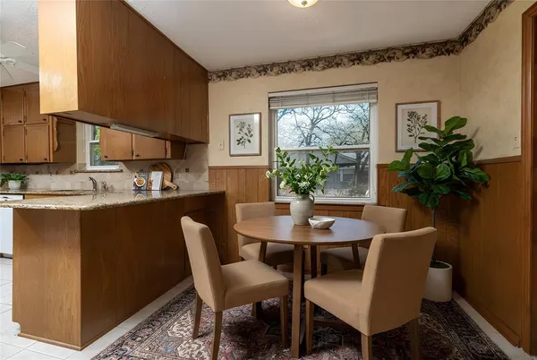 a kitchen with a stove a sink and a microwave oven