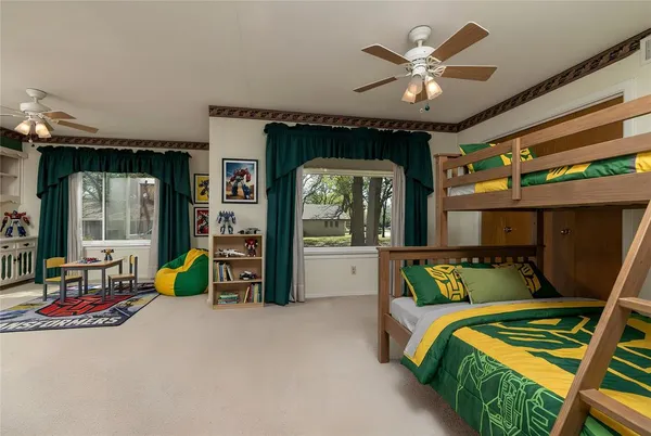 a view of a livingroom with a ceiling fan and a large window