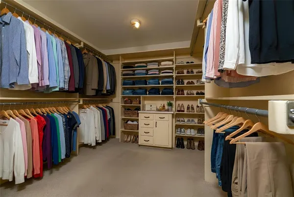 a view of walk in closet with empty racks