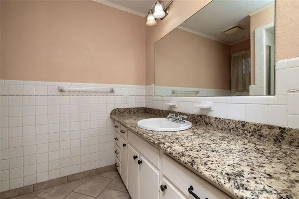 a bathroom with a sink a vanity and a mirror