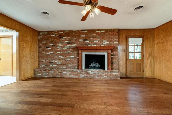 a dining room with furniture a potted plant and a window