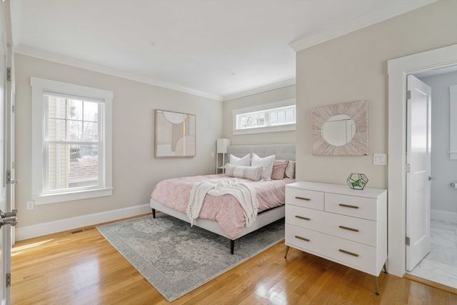 a spacious bedroom with a bed and a window