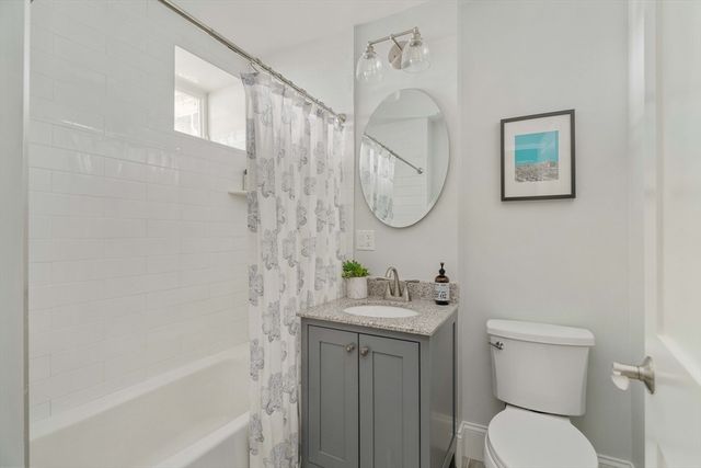 a bathroom with a toilet sink and shower