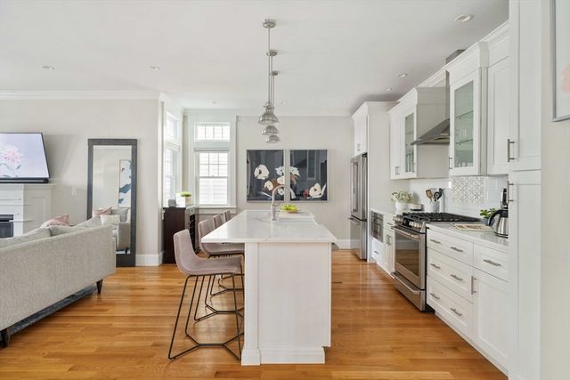 a large white kitchen with cabinets