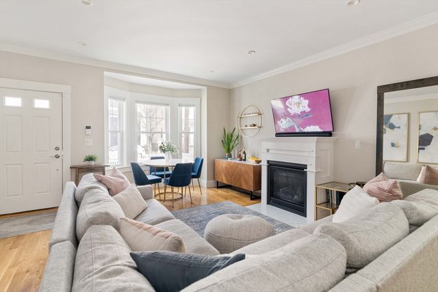 a living room with furniture fireplace and window