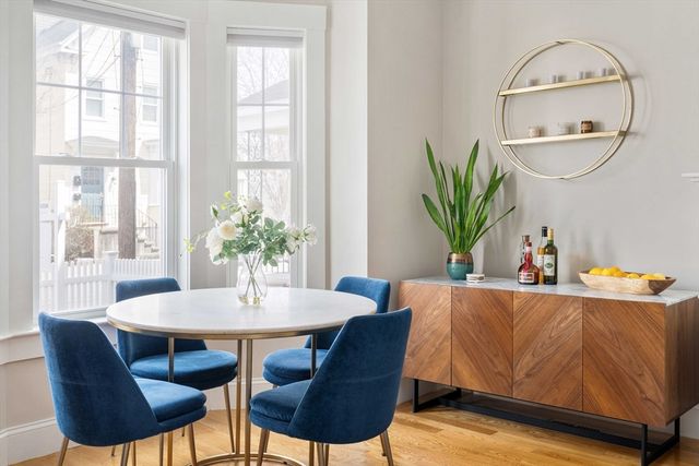 a dining room with furniture and wooden floor