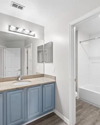 a bathroom with a sink double vanity and a mirror