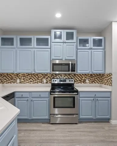 a kitchen with granite countertop a stove and a sink