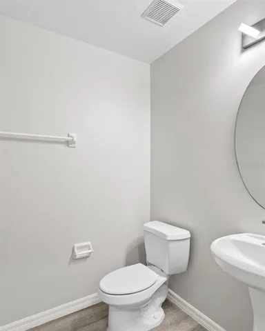 a white toilet sitting next to a shower