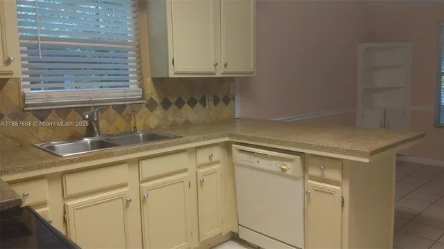 a kitchen with a sink and cabinets
