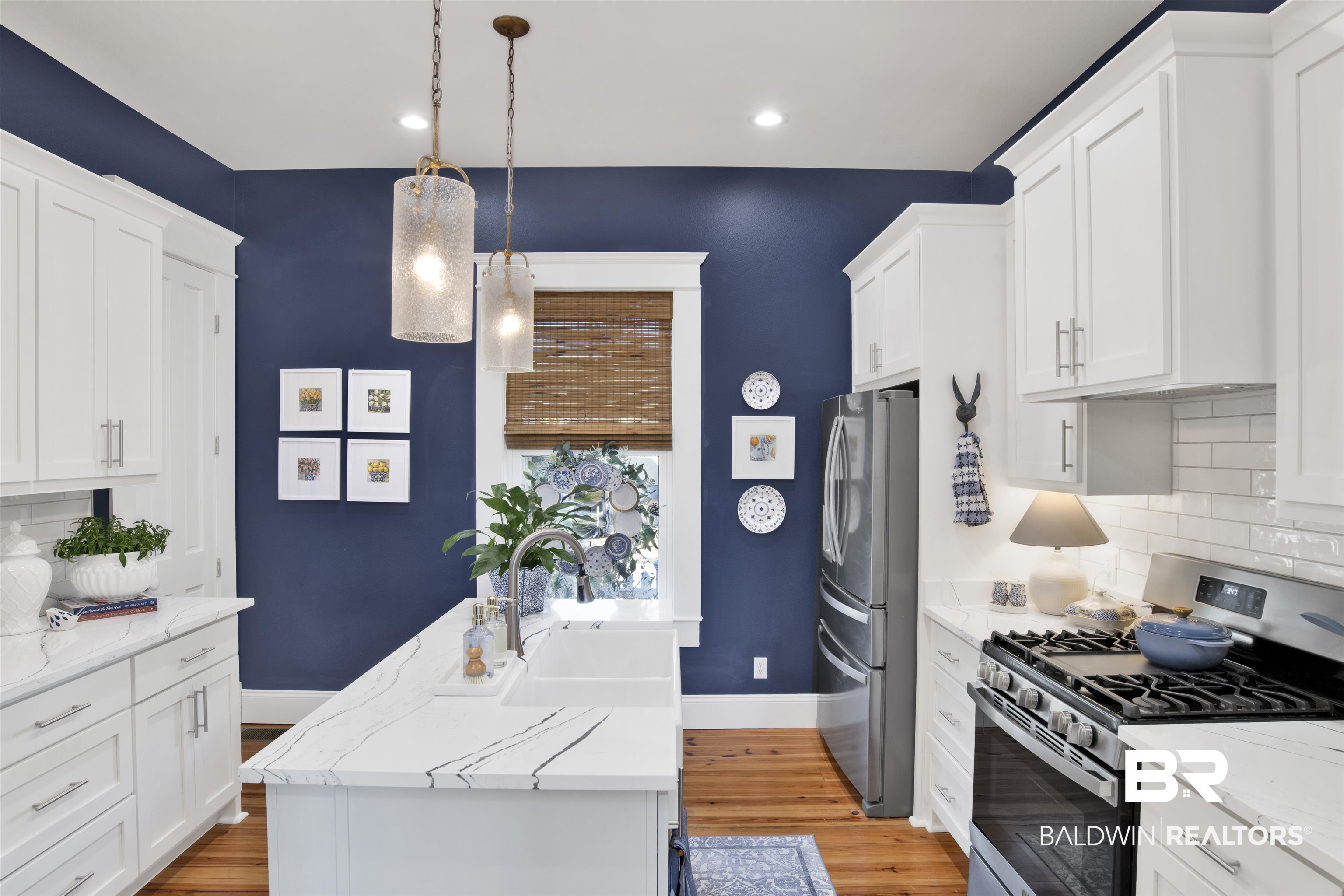 12094 Old Federal Road Magnolia Springs, AL 36555 - Photo 13 of 48 Kitchen featuring decorative backsplash, pendant lighting, white cabinets, and stainless steel appliances