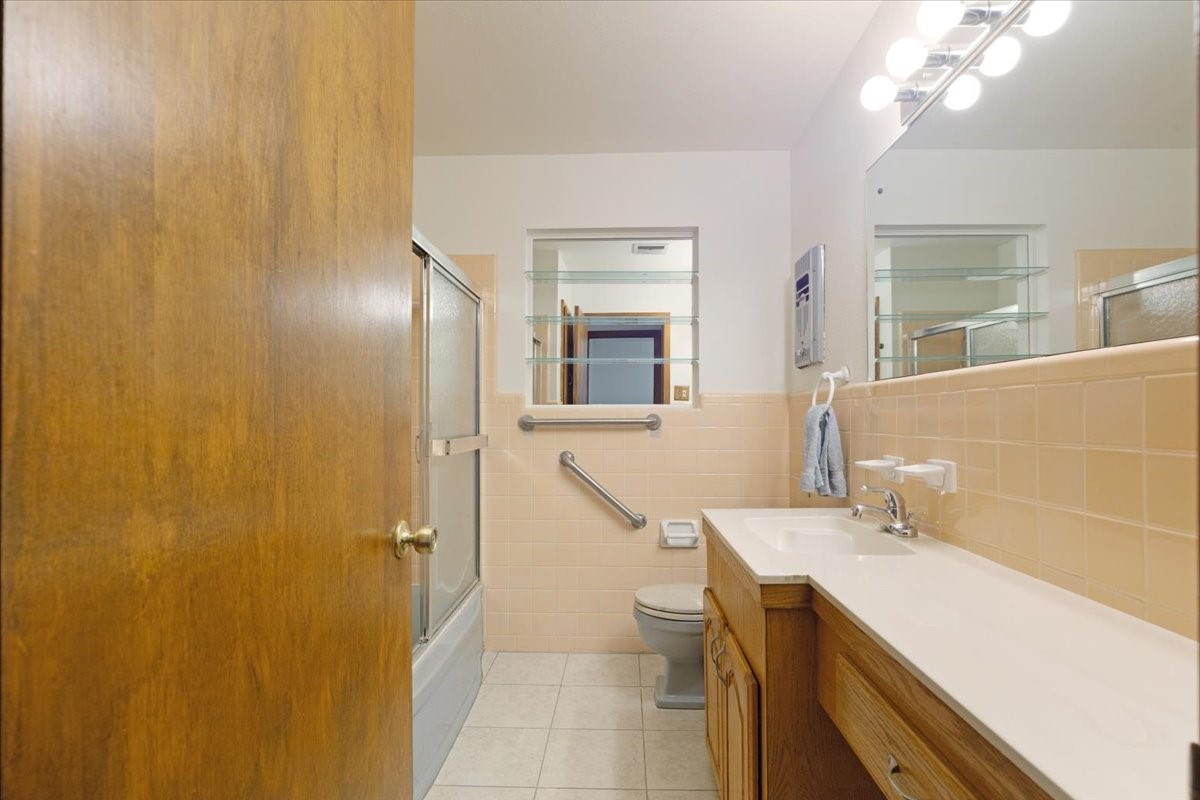 1403 Marlock Lane Pasadena, TX 77502 - Photo 23 of 32 a bathroom with a sink a mirror and a shower