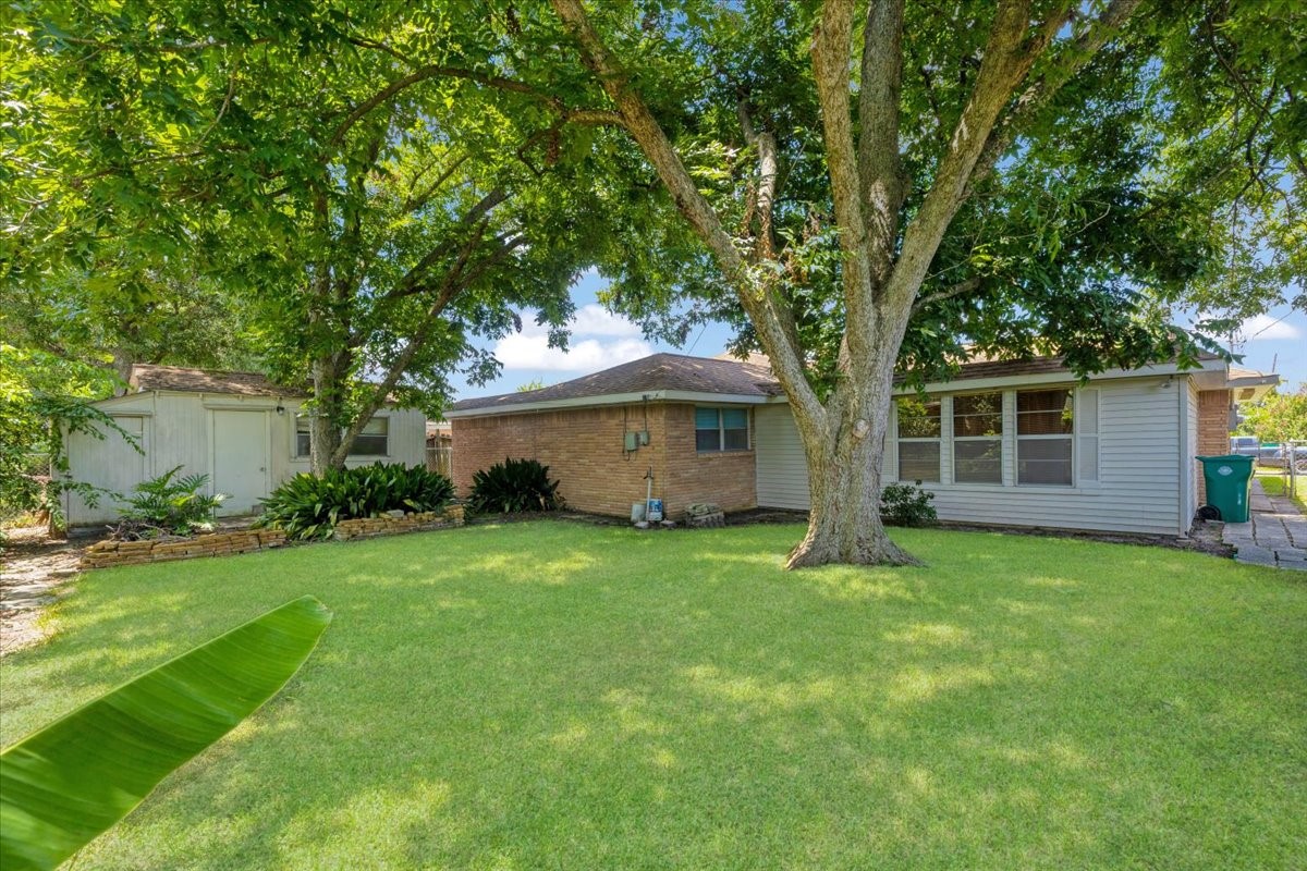 1403 Marlock Lane Pasadena, TX 77502 - Photo 29 of 32 a view of a house with a big yard and large trees