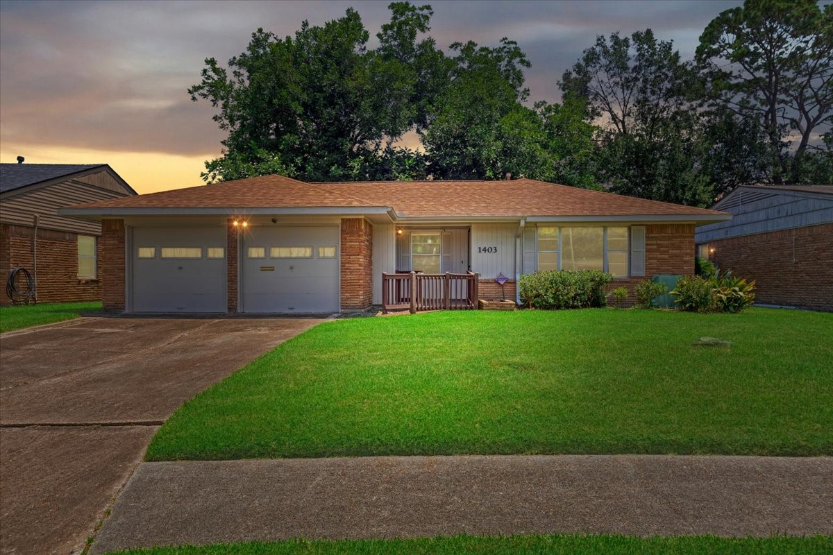1403 Marlock Lane Pasadena, TX 77502 - Photo 31 of 32 a front view of a house with a garden and plants