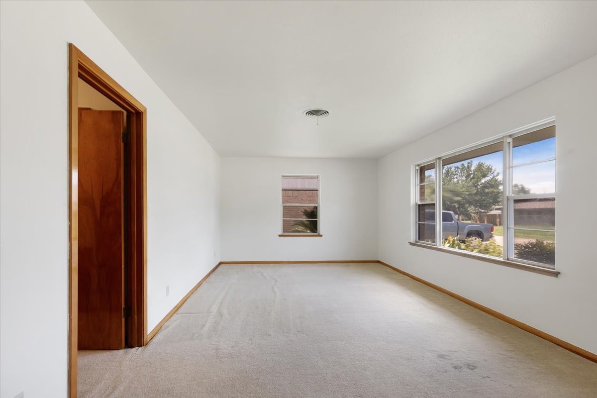 1403 Marlock Lane Pasadena, TX 77502 - Photo 5 of 32 an empty room with windows and bed