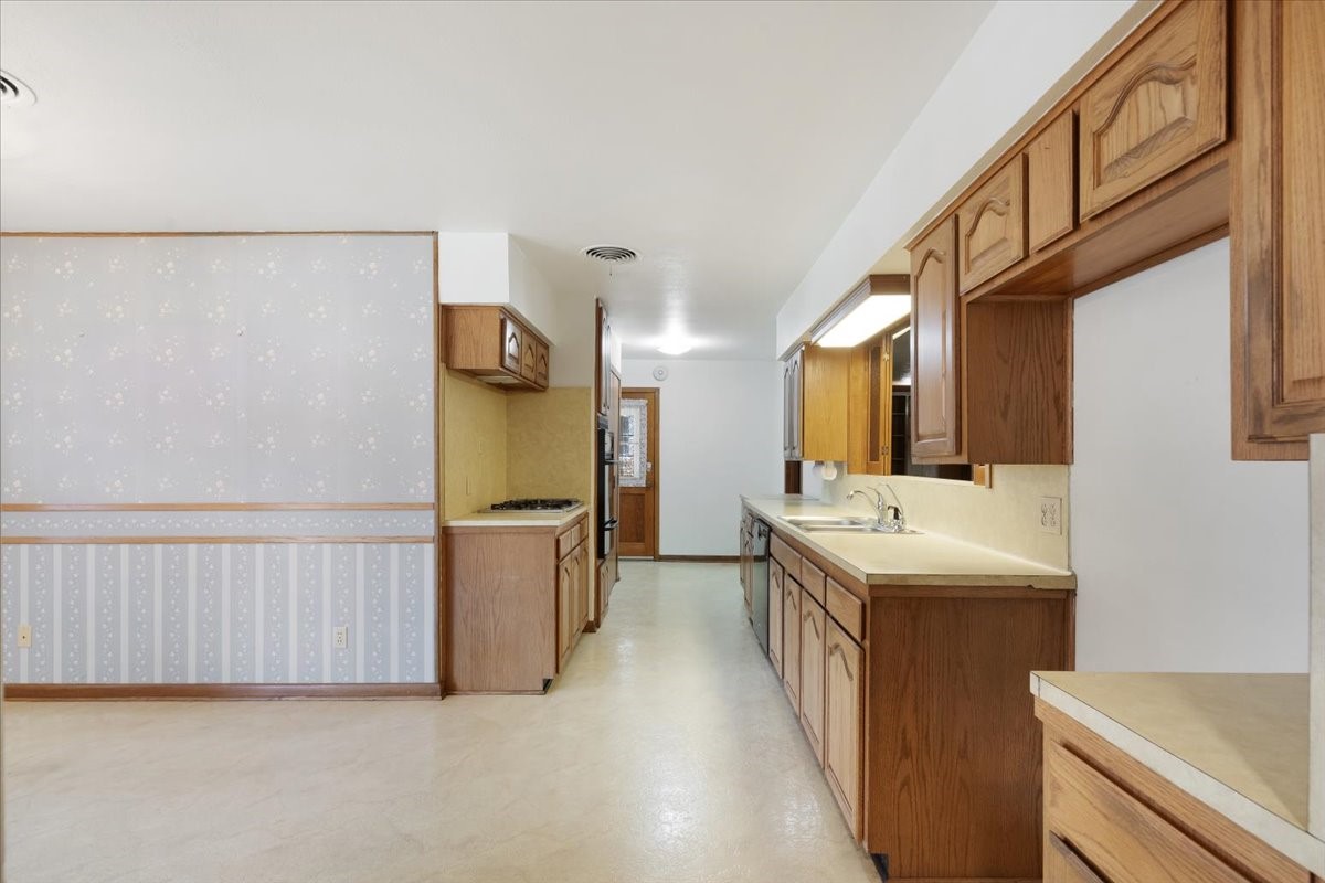 1403 Marlock Lane Pasadena, TX 77502 - Photo 8 of 32 a kitchen with a sink and a refrigerator